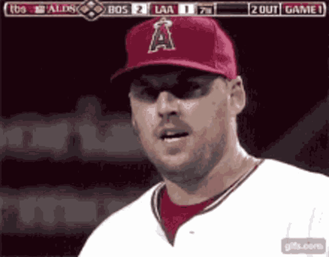 a baseball player wearing a red hat with a letter a on it