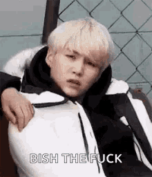 a man in a white jacket is holding another man 's shoulder and says `` bish the fuck '' .