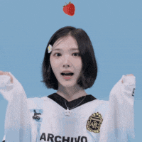 a girl wearing a white sweater with the word rchino on the front