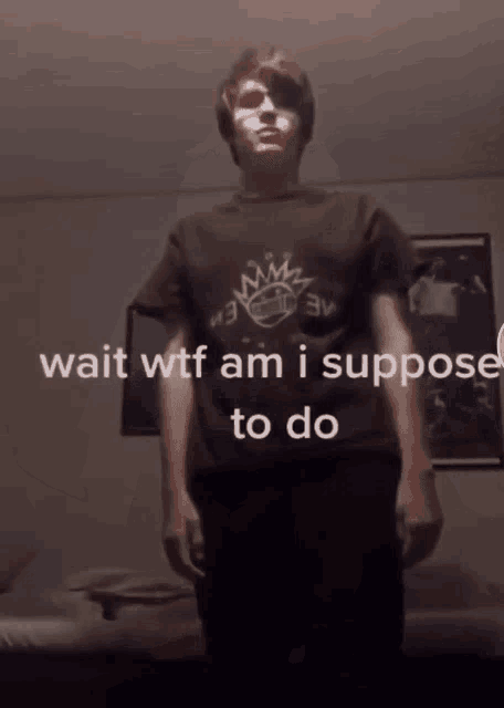 a man wearing a t-shirt that says wait wtf am i supposed to do