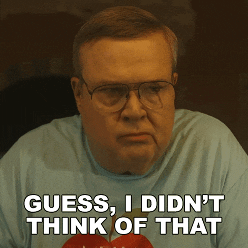 a man wearing glasses and a shirt that says guess i did n't think of that