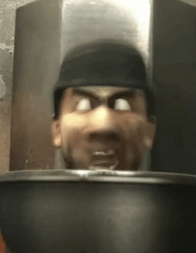a close up of a man 's face with a bowl in front of him .