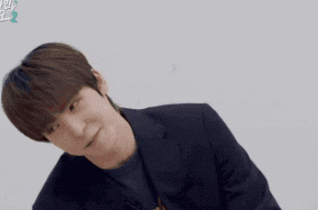 a man in a suit is making a funny face in korean