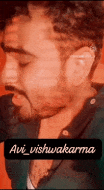 a close up of a man 's face with a beard and the name avi written on it .