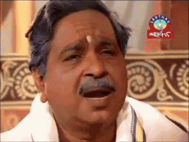 a man with a mustache is making a funny face in front of a sign that says ' sarthak '