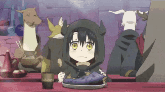 a girl with horns is sitting at a table with a plate of food and a cup of tea .