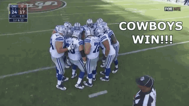 a group of cowboys football players huddled together on the field