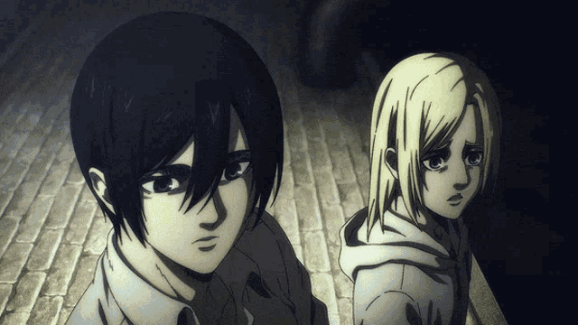 a man and a girl are standing next to each other in a dark room