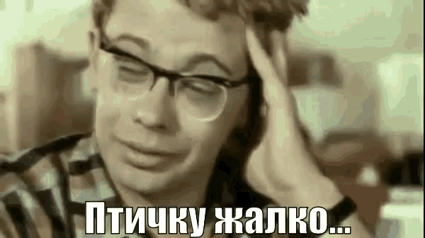 a man wearing glasses is talking on a cell phone while holding his head .