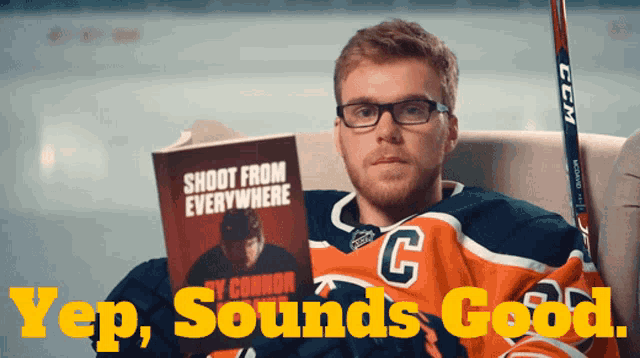 a hockey player reading a book titled shoot from everywhere