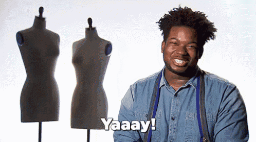 a man in a denim shirt is standing in front of mannequins and saying yaaay