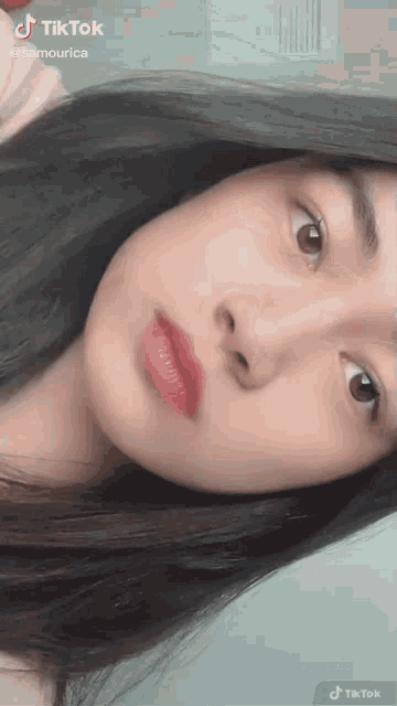 a close up of a girl 's face with a tiktok watermark on it