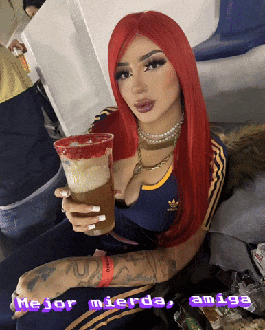 a woman with red hair is holding a drink with the words mejor mierda amiga written below her