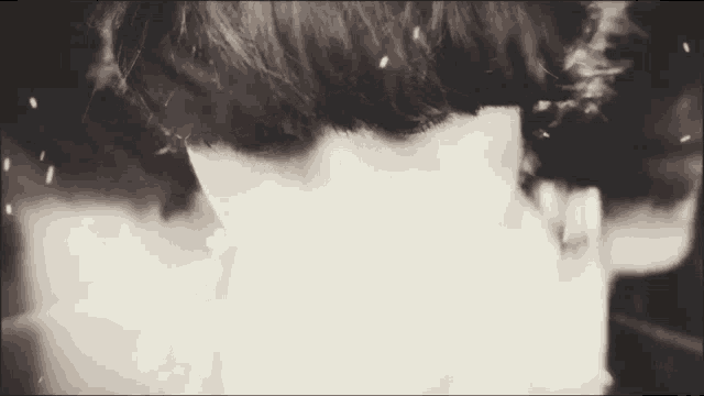 a black and white photo of a person 's face with smoke coming out of it