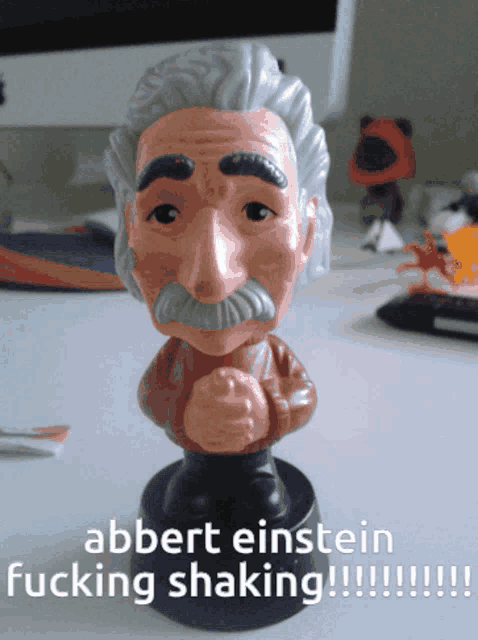 a bobble head of albert einstein with the words albert einstein fucking shaking