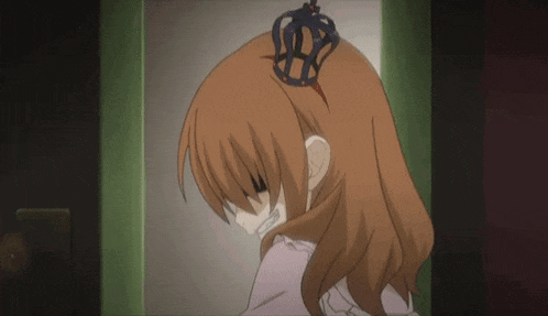 a girl with a crown on her head looks down at something