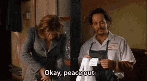 a man and woman are standing next to each other and the man is holding a piece of paper that says okay peace out