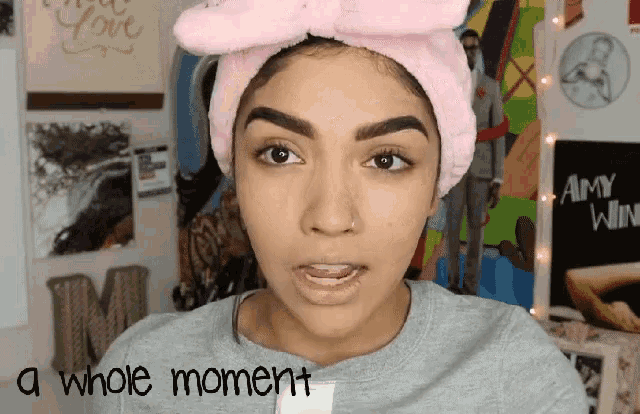 a woman wearing a pink headband with the words " a whole moment " on the bottom