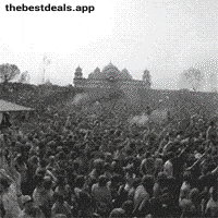 a large crowd of people are gathered in a park in front of a castle .