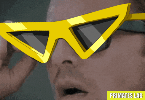 a man wearing a pair of yellow sunglasses with a primates lab logo below him