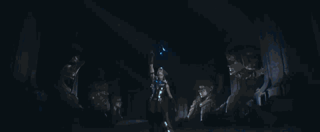 thor is holding a lightning hammer in a dark room .