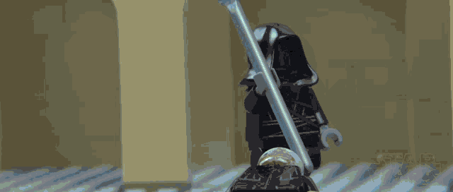a lego figure holding a spear with the word star wars on the bottom