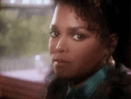 a close up of a woman 's face in a blurry photo .