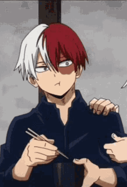 a close up of a person holding chopsticks in their hands .