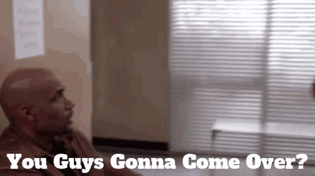 a man sitting in a hallway with the words you guys gonna come over