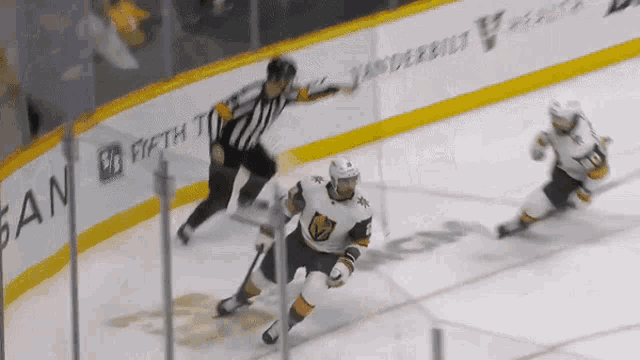 a hockey game is being played in front of a wall that says fifth