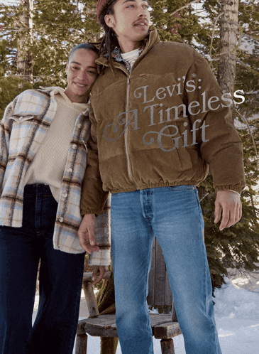 a man in a levi 's timeless gift jacket stands next to a woman in a plaid shirt