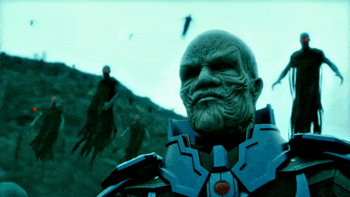 a man with a beard and red eyes is surrounded by a group of ghosts