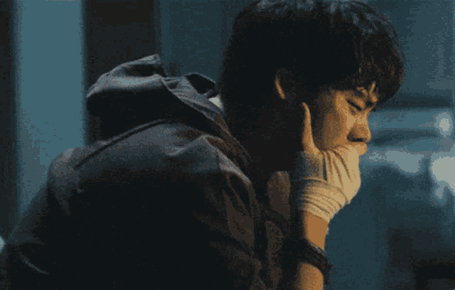 a man with a bandage on his wrist is looking down