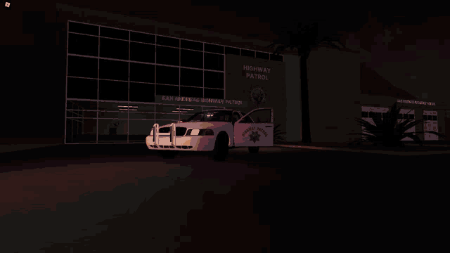 a highway patrol car is parked in front of the building