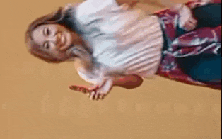 a woman wearing a plaid shirt is standing upside down .