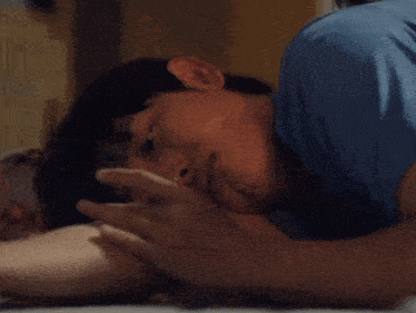 a close up of a person laying on their back with their eyes closed