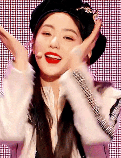 a woman wearing a beret and a fur coat is making a face