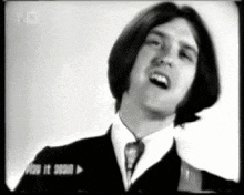 a black and white photo of a man in a suit and tie with a n3 logo in the corner