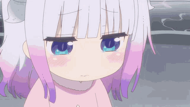 a close up of a girl 's face with tears in her eyes