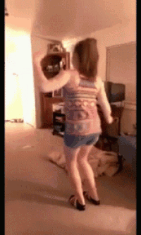 a girl in a striped tank top and shorts is dancing