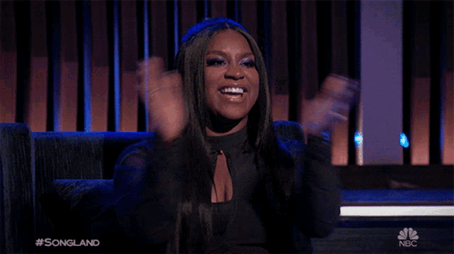 a woman applauds during a songland show