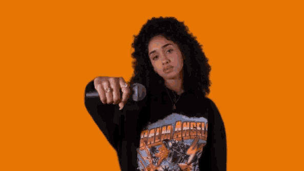 a woman wearing a black shirt that says " palm angels "