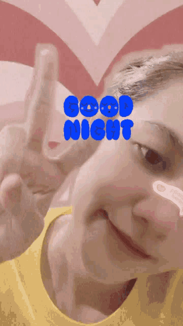 a woman giving a peace sign with the words good night on her face