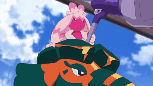 a pink bunny is sitting on top of a green and orange monster