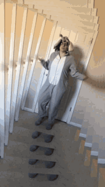 a man in a bunny costume stands in a hallway