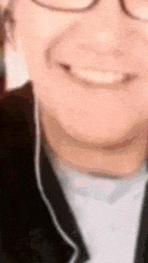 a close up of a person 's face with glasses and headphones