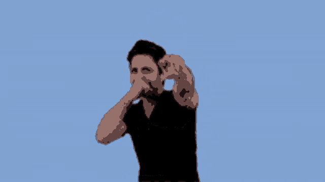 a man in a black shirt is covering his mouth with his fist