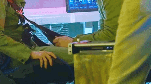 a man and a woman are sitting next to each other in a room .