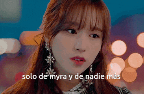 a close up of a woman 's face with the words solo de myra y de nadie mas