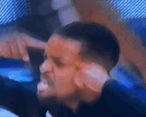 a blurry picture of a man 's face with a blue background